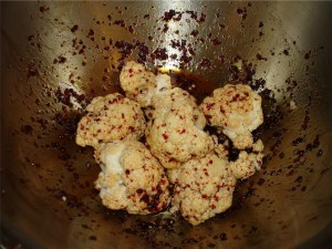 Coating cauliflower in spices and oil